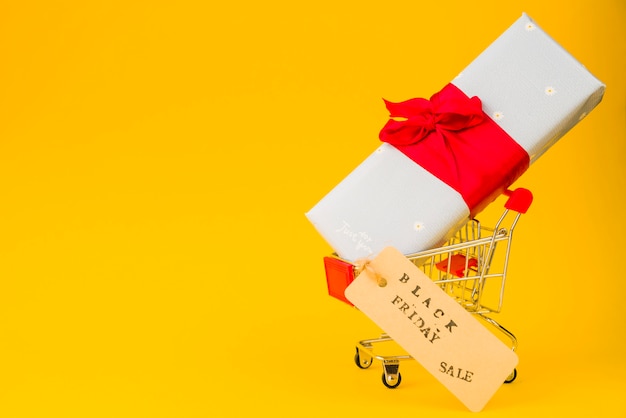 Shopping trolley with present box and sale tag 