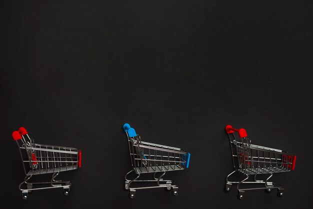 Shopping trolleys with red and blue handles 