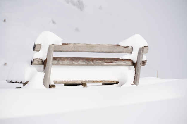 Free photo shot of a bench covered with snow