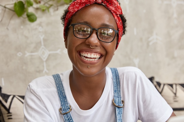 Shot of black woman has satisfied expression