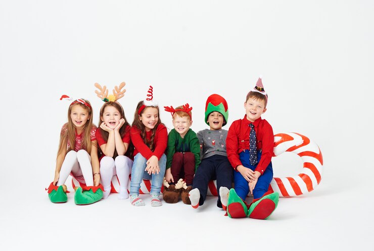 Free Photo shot of children sitting on big candy cane
