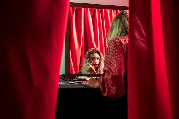 Shot between curtains of a dressed woman