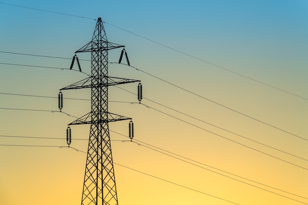 A shot of an electric tower during a sunset.