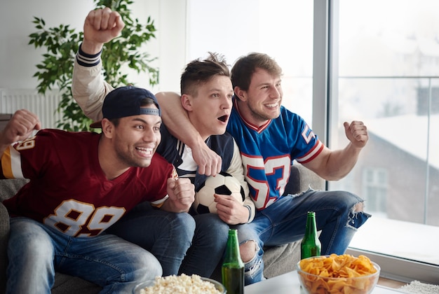 Shot of hardcore soccer fans celebrating