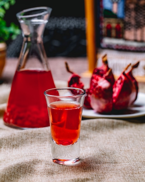 Shot of pomegranate juice jugfruit side view