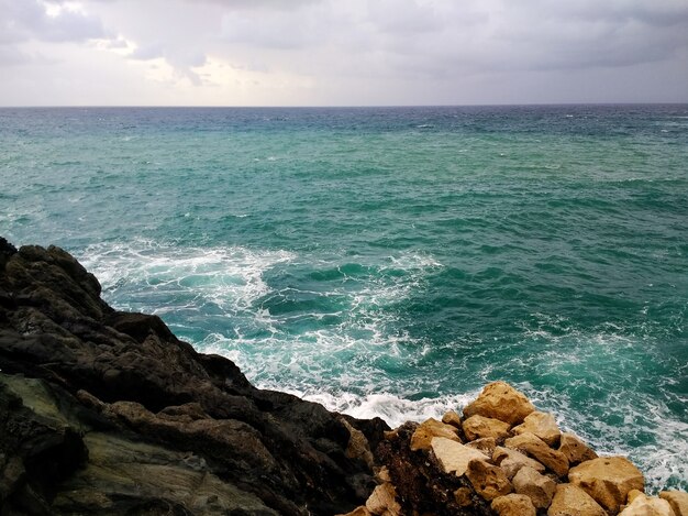 Снимок скалистого берега на острове Фуэртевентура, Испания в пасмурную погоду