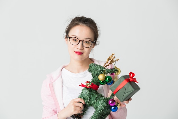 Shot in the studio of the young asian woman with a Christmas gift