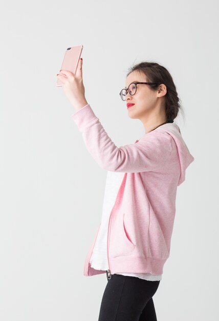 Shot in the studio of young Asian women in the use of mobile phone company