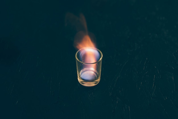 Shot of tequila glass on fire