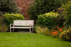 Free photo shot of a white bench in a park