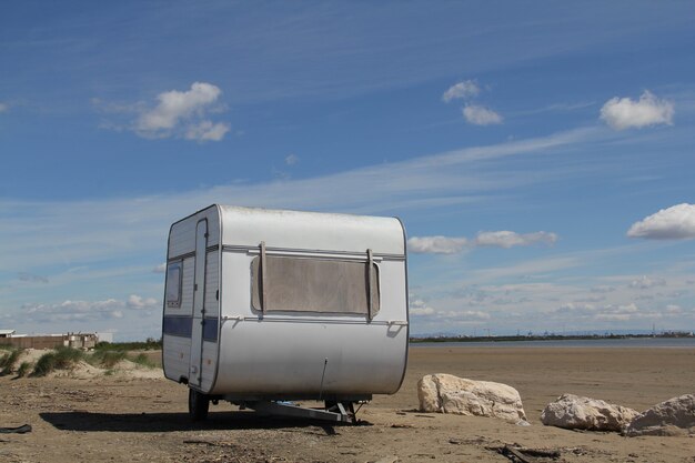 Shot of a white, old  travel trailer on the ground