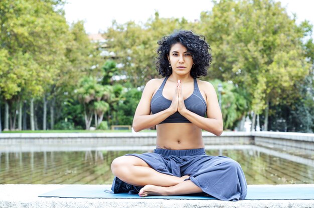 Shot of a woman doing yoga in a park