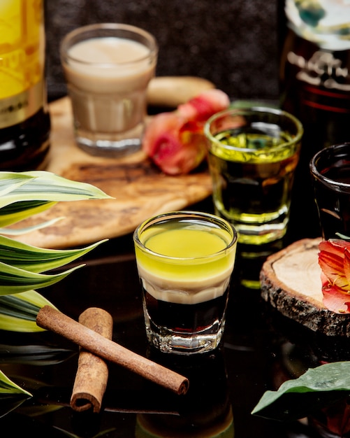 Shots of cocktails with cinnamon on the table