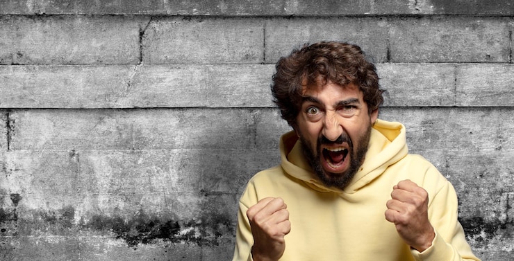 Free Photo shouting aggressively with annoyed frustrated angry look and tight fists feeling furious