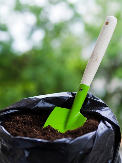 Shovel inside soil bag