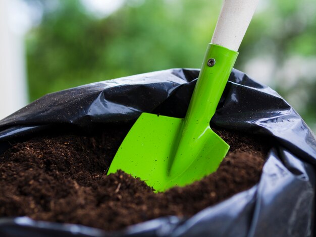 Shovel inside soil bag