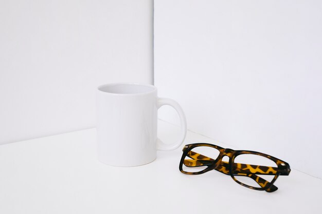 Showcase concept with mug and glasses