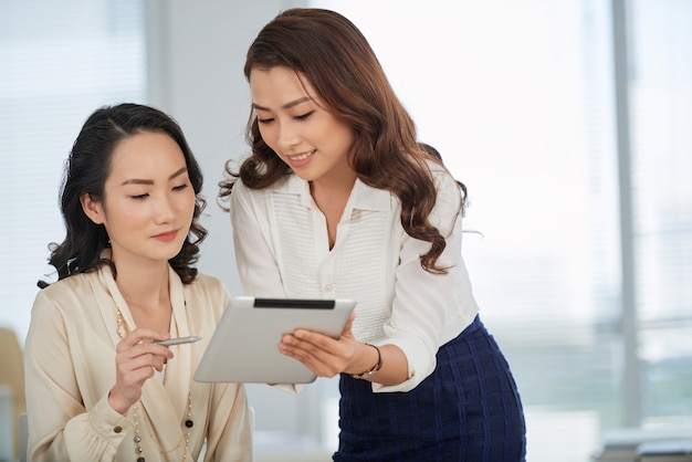 Showing business document to colleague