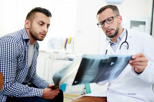 Showing x ray images to patient