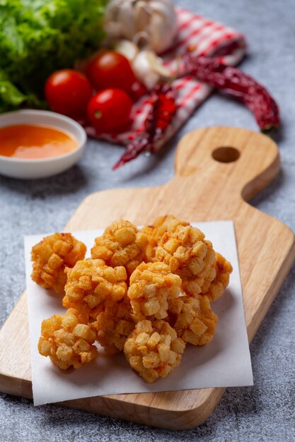 Shrimp balls covered with breaded fried on the dark surface.