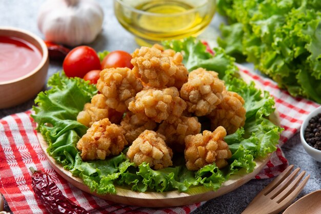 Shrimp balls covered with breaded fried on the dark surface.