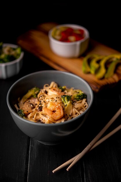 Shrimp and noodles in bowl with chopsticks