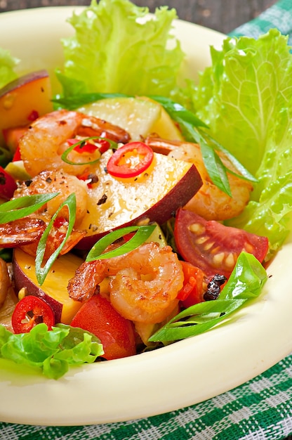 Shrimp salad with peaches, tomato, avocado and lettuce