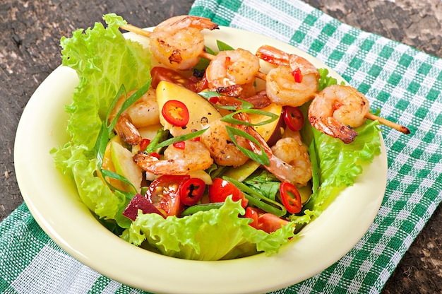 Shrimp salad with peaches, tomato, avocado and lettuce