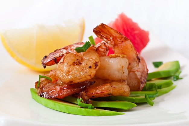 Shrimp sauteed with garlic and soy sauce on a cushion of avocado slices