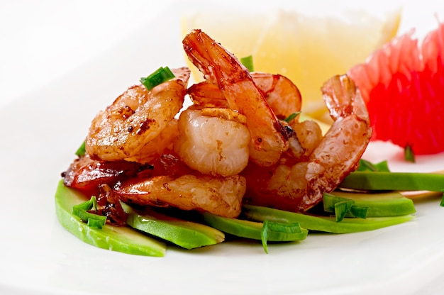 Shrimp sauteed with garlic and soy sauce on a cushion of avocado slices