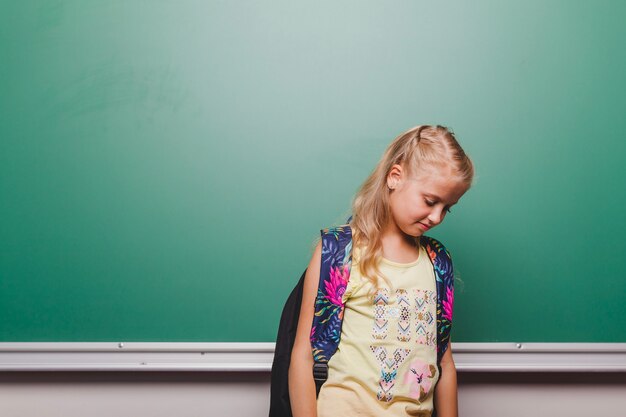 Shy girl at blackboard