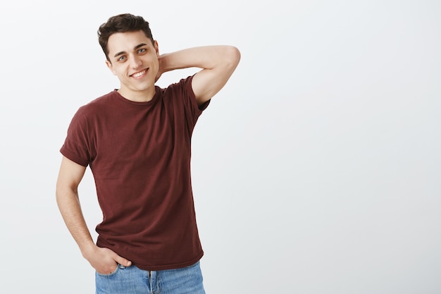 Free photo shy good-looking masculine guy in red t-shirt