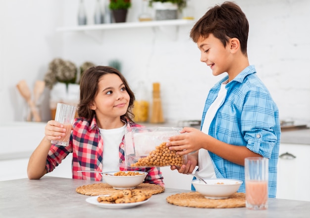 Siblings at home helping each other