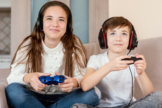 Siblings at home playing games