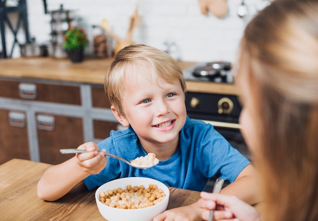 Siblings looking at each other while eating