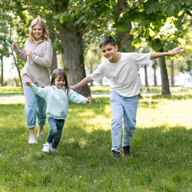 Siblings and mom running together