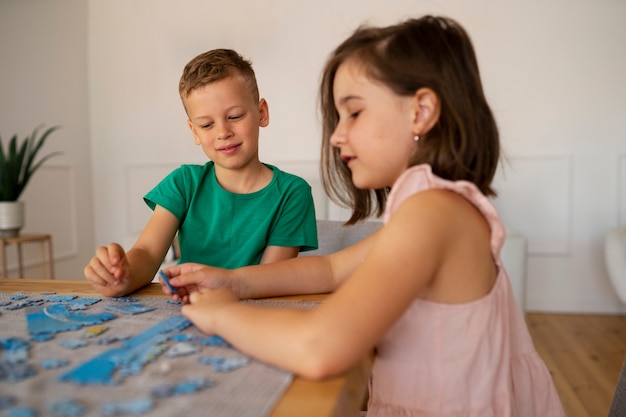 Siblings playing with brain teaser toys