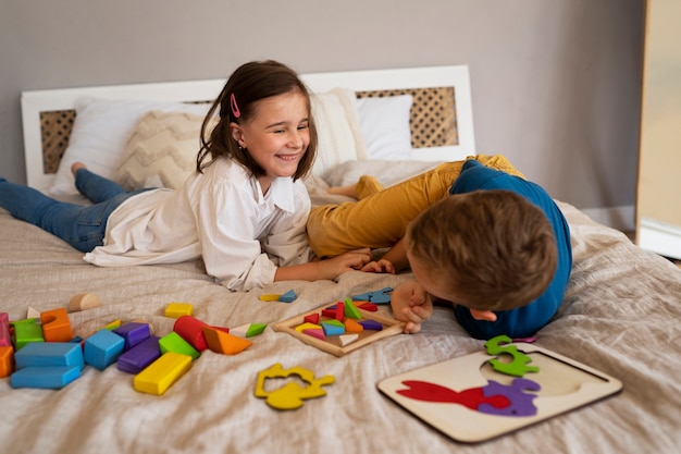 Siblings playing with brain teaser toys