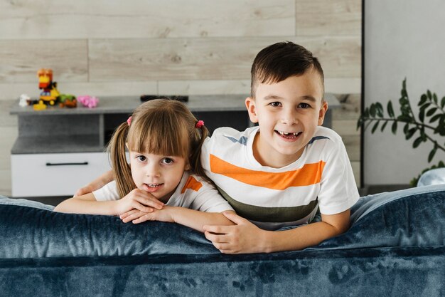 Siblings sitting together on the couch