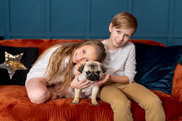 Siblings spending time together with their adorable dog