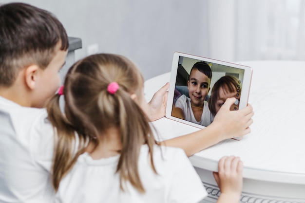 Siblings taking a self portrait on digital tablet