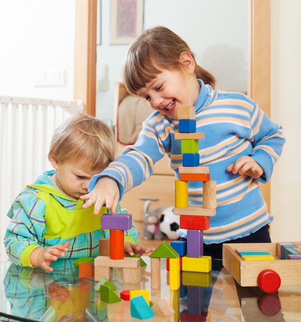 Free photo siblings together playing with  toys