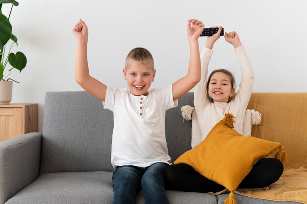 Siblings watching television together