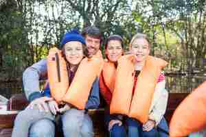 Free photo siblings with their parents enjoying outdoors