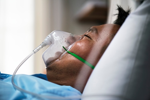 a sick asian man in a hospital