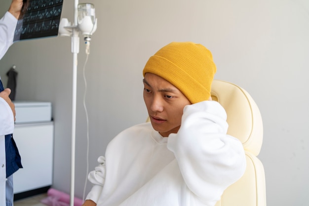sick asian man sitting on chair medium shot