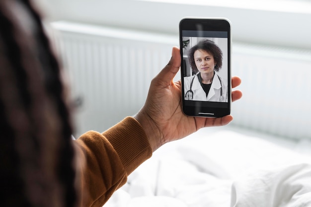 Sick man having a video call with a doctor