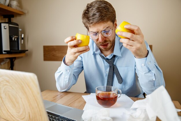 Sick man while working in office, businessman caught cold, seasonal flu.