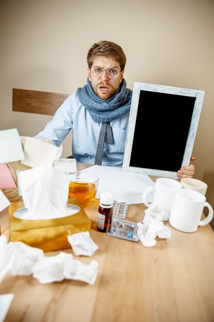 Больной человек во время работы в офисе, бизнесмен простудился, сезонный грипп.