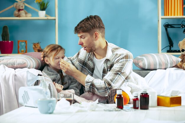 Sick man with daughter at home. Home Treatment. Fighting with a desease. Medical healthcare. Family iIlness. The winter, influenza, health, pain, parenthood, relationship concept. Relaxation at Home